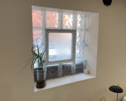 Narrow exterior basement doorway with restricted access serving a finished lower level