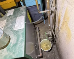 Boiler – Leak Collected in a Bucket Bucket placed under boiler piping to catch dripping water