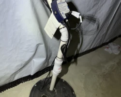Sump Pump – Not Plugged In Sump pump sitting in a basement pit with its power cord unplugged