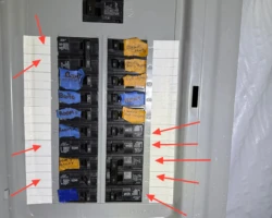 Open electrical panel with several breakers left unlabeled