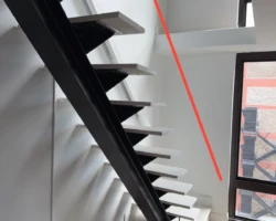 Interior staircase with an open unguarded side above a substantial drop