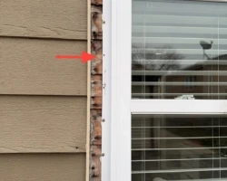 Bare house wrap and sheathing left exposed around the edge of an exterior window