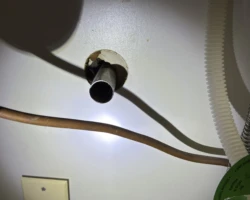 Drain Pipe – Open and Unsealed at the Wall Unfinished open drain pipe under a sink cabinet, not sealed at the wall penetration
